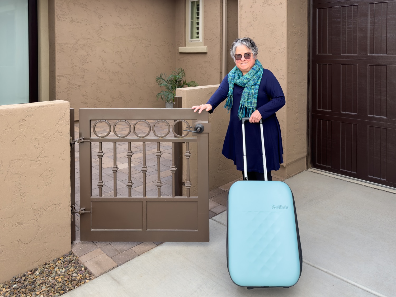 Flex Vega carry-on suitcase rolling into the courtyard