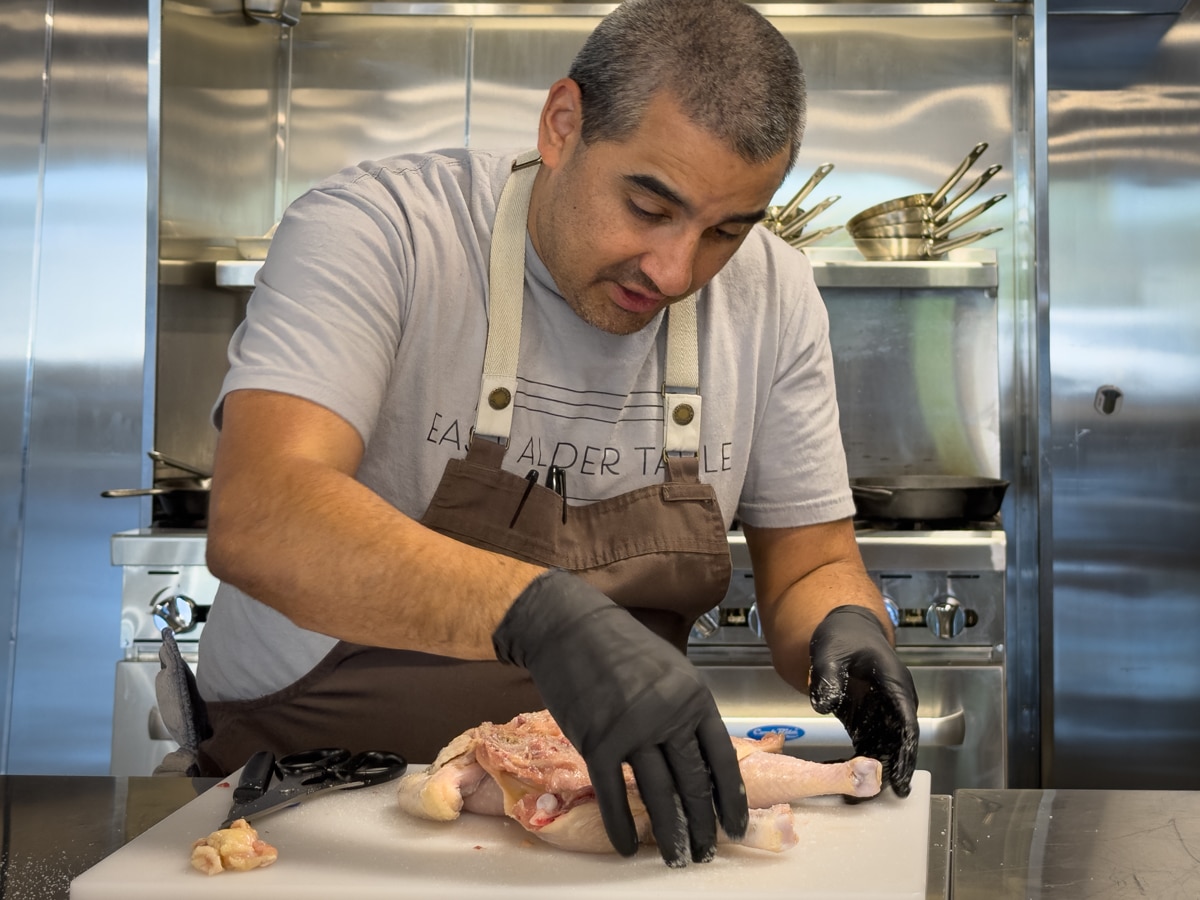 Chef Rock Silva demonstrates spatchcock chicken at East Alder Table